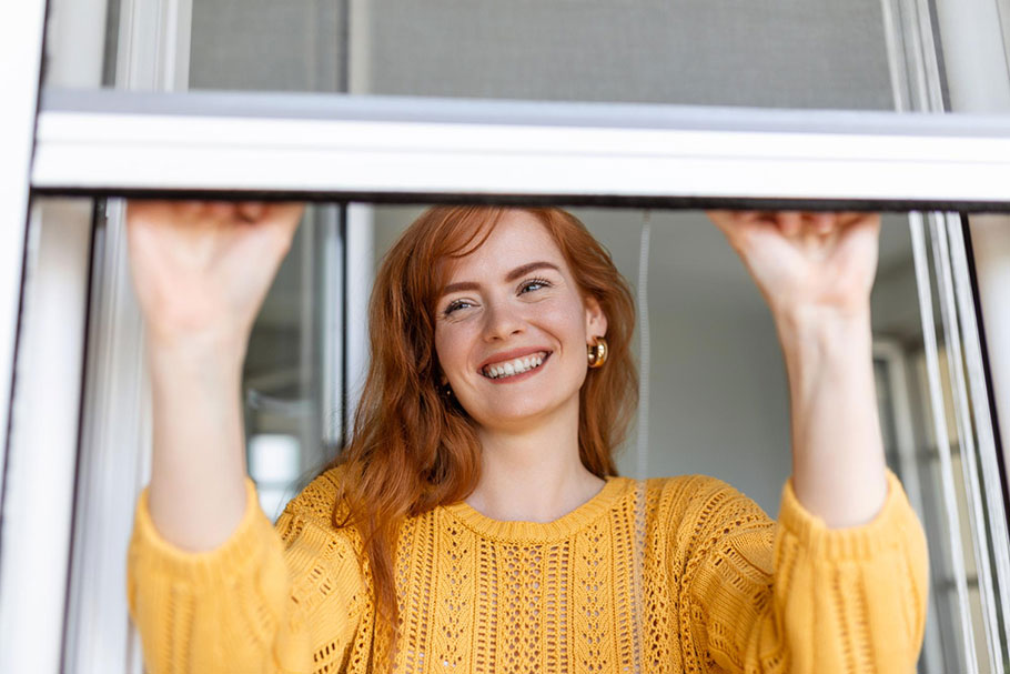 woman holding window open