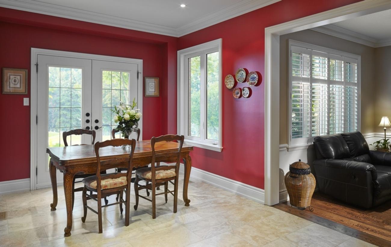 Kitchen with red walls and white windows and garden doors