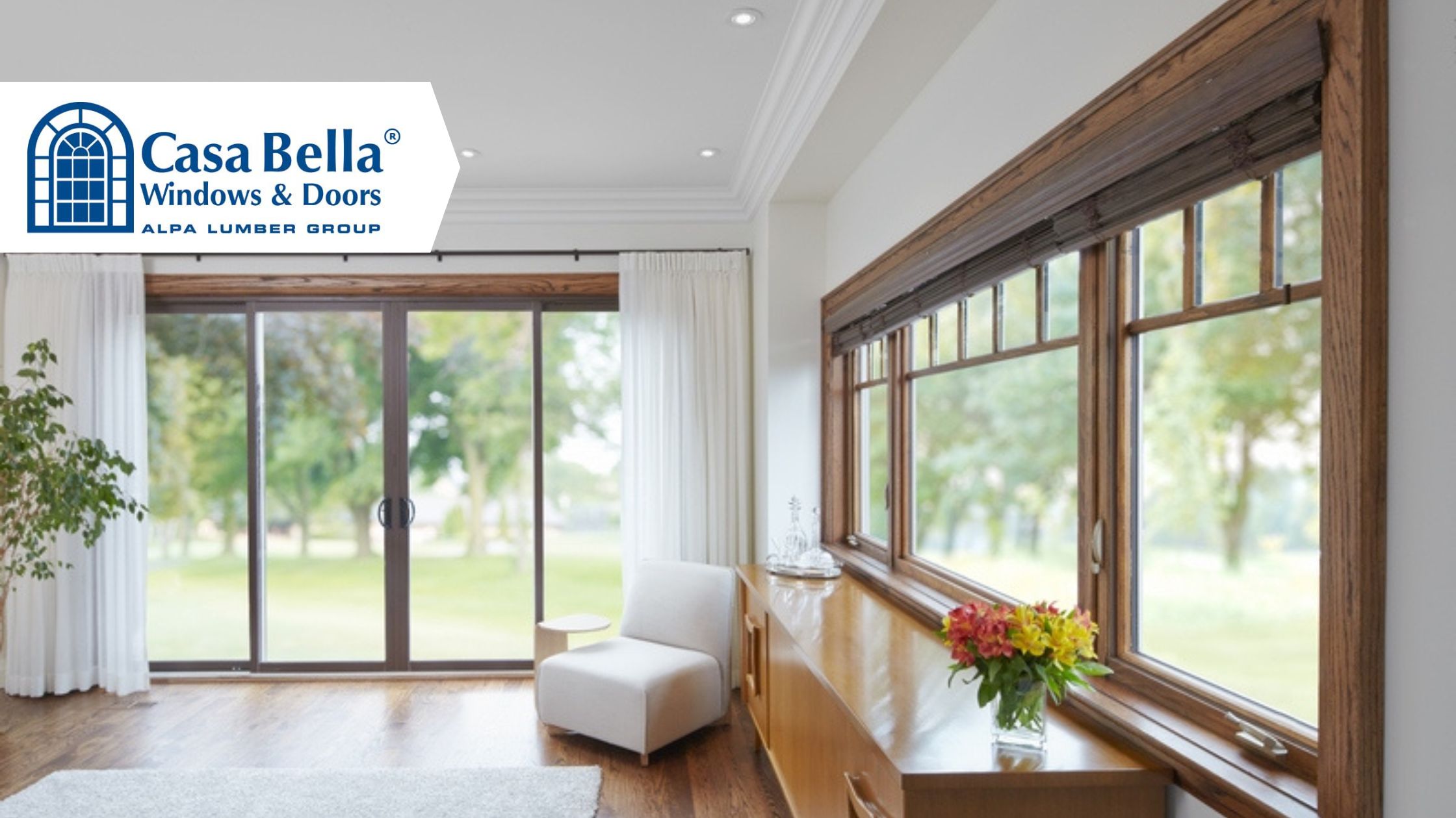 Bright living room with wood trim windows and patio doors by Casa Bella Windows, highlighting solutions for drafty windows in Canadian homes.