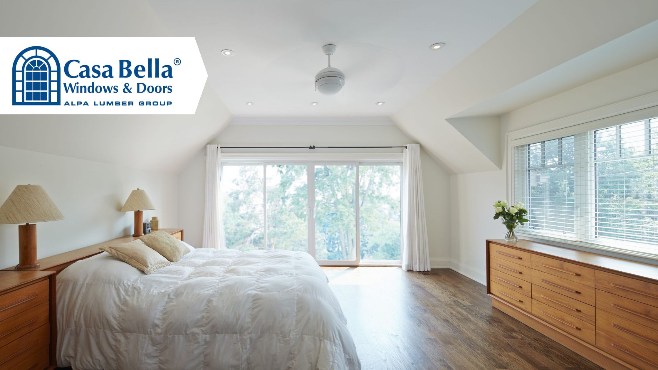 Bright bedroom featuring Casa Bella sliding patio doors and large windows, showcasing natural light and modern design.