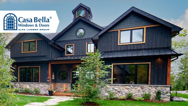 A modern black board-and-batten home featuring large Casa Bella windows and doors with natural wood trim, showcasing energy-efficient and stylish exterior design.